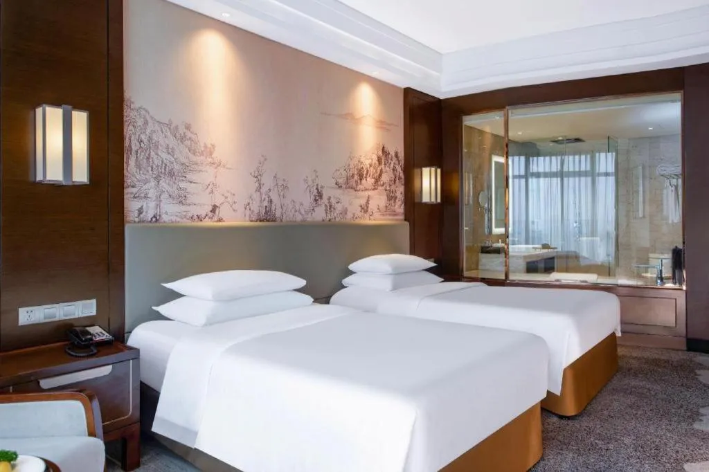 Bed in New Century Grand Hotel Hangzhou Fuyang Dongfangmao