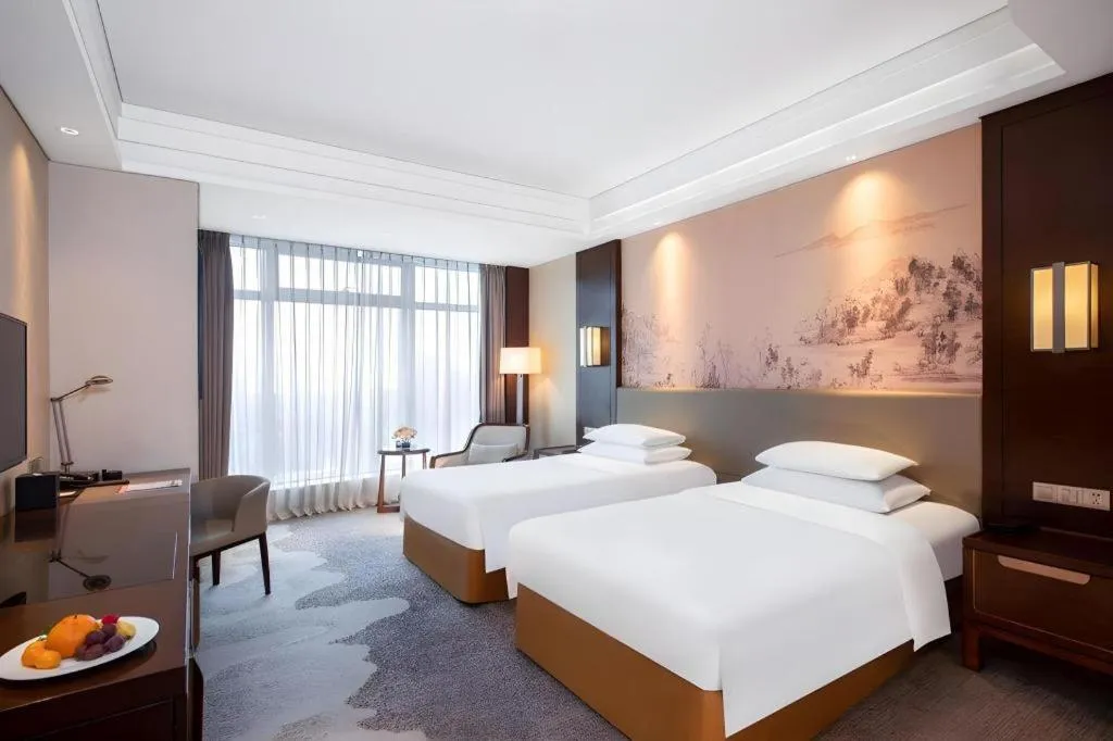 Bed in New Century Grand Hotel Hangzhou Fuyang Dongfangmao