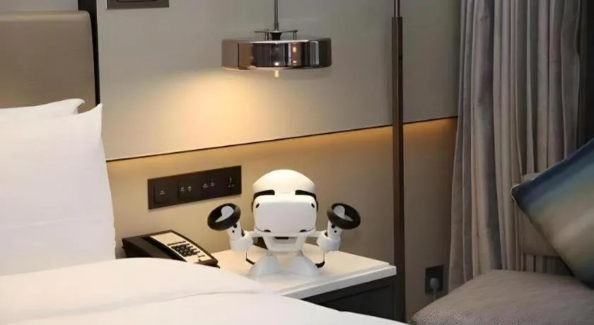 Bed in New Century Grand Hotel Hangzhou Fuyang Dongfangmao