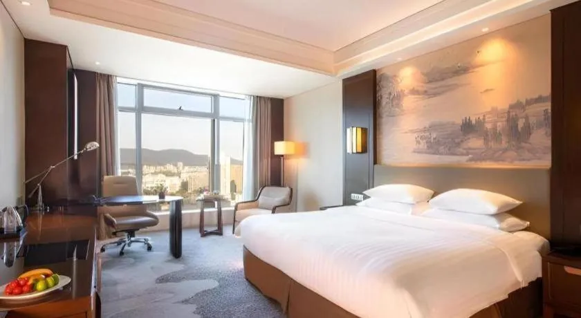 Bed in New Century Grand Hotel Hangzhou Fuyang Dongfangmao