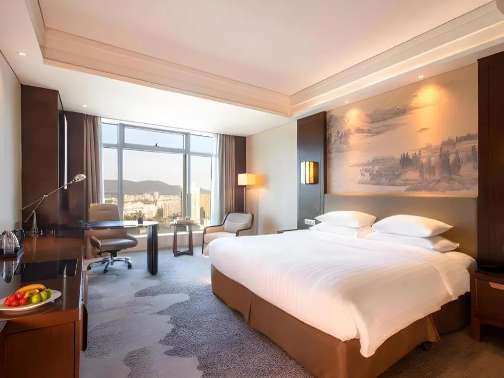 Bed in New Century Grand Hotel Hangzhou Fuyang Dongfangmao