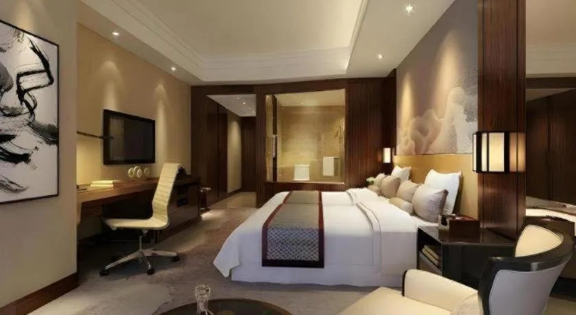 Bed in New Century Grand Hotel Hangzhou Fuyang Dongfangmao