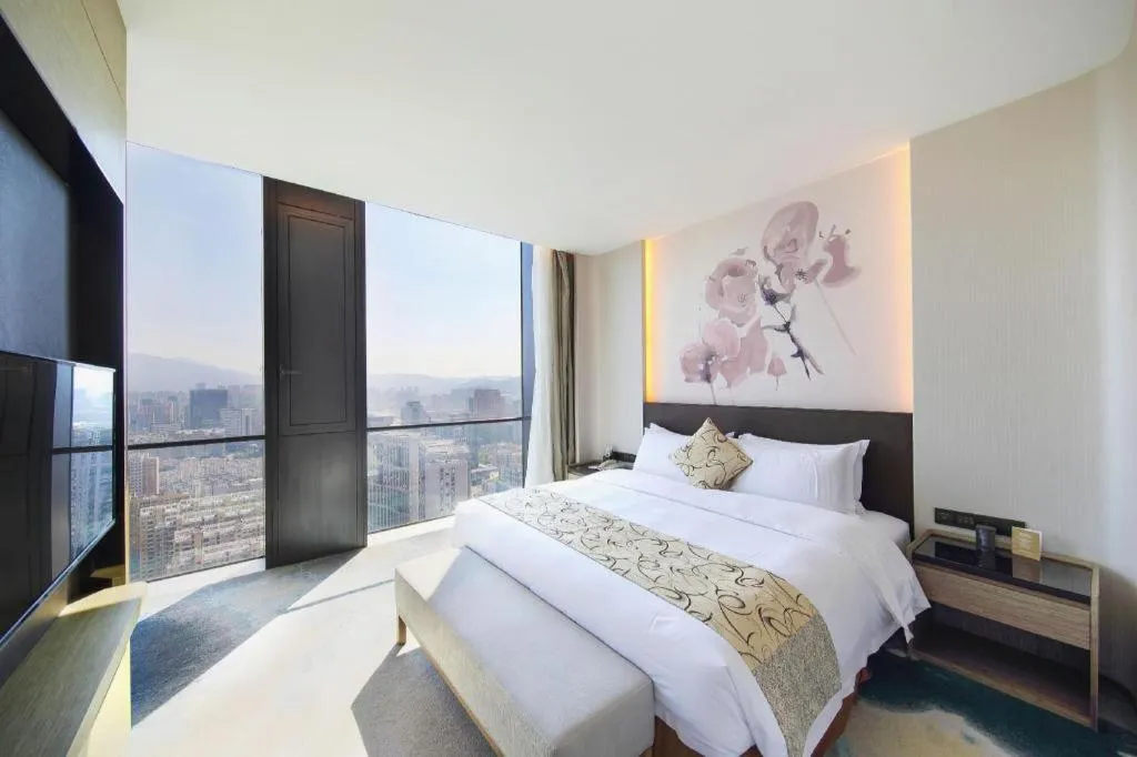 Bed in LONGYAN JINGHUA FLIPORT HOTEL