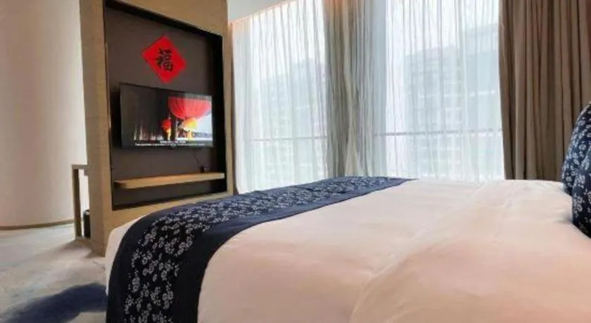 Bed in LONGYAN JINGHUA FLIPORT HOTEL