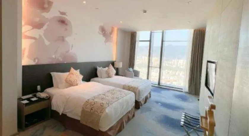 Bed in LONGYAN JINGHUA FLIPORT HOTEL