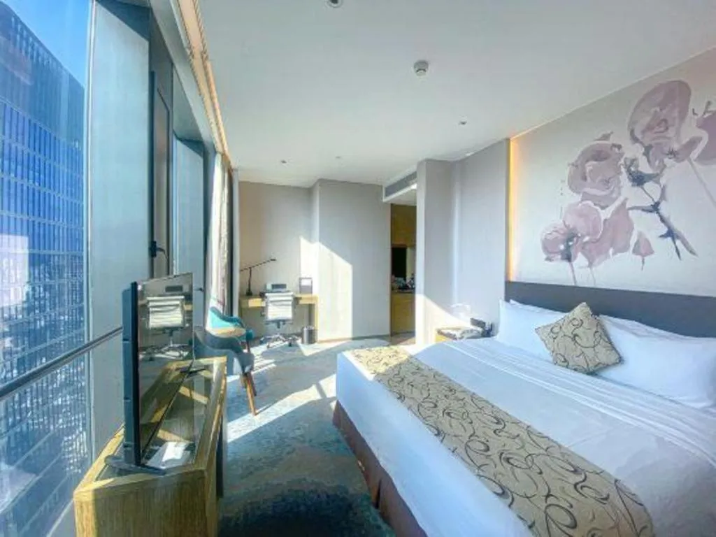 Bed in LONGYAN JINGHUA FLIPORT HOTEL