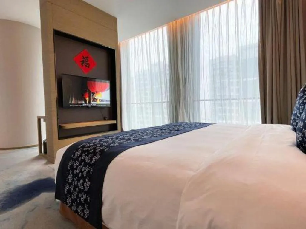 Bed in LONGYAN JINGHUA FLIPORT HOTEL