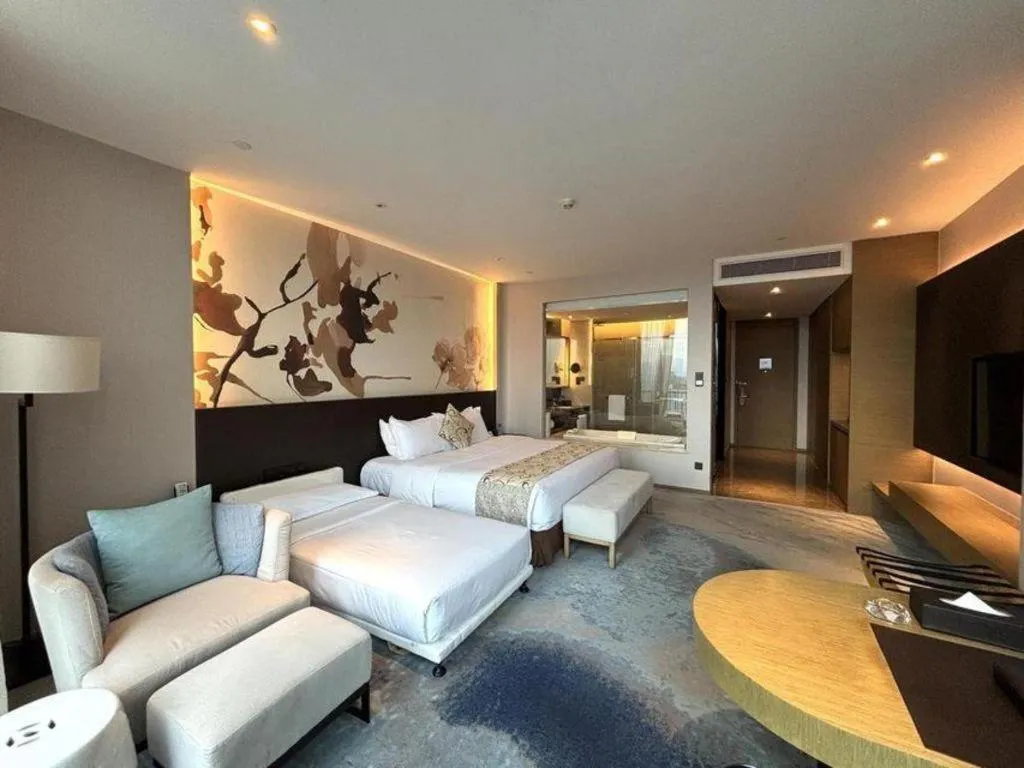 Bed in LONGYAN JINGHUA FLIPORT HOTEL