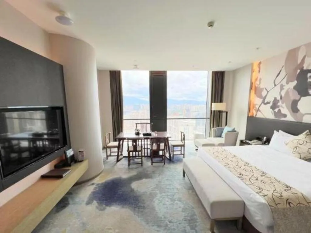 Bed in LONGYAN JINGHUA FLIPORT HOTEL