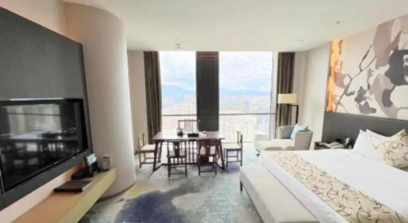 Bed in LONGYAN JINGHUA FLIPORT HOTEL