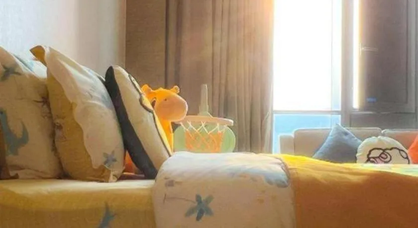 Bed in LONGYAN JINGHUA FLIPORT HOTEL