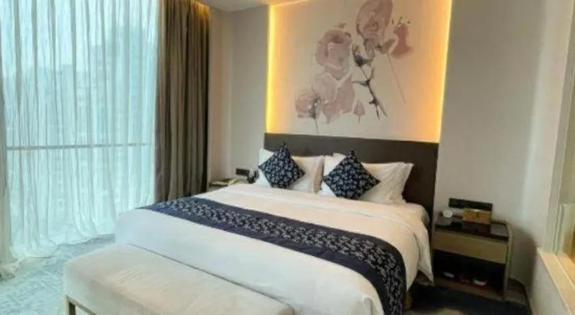 Bed in LONGYAN JINGHUA FLIPORT HOTEL