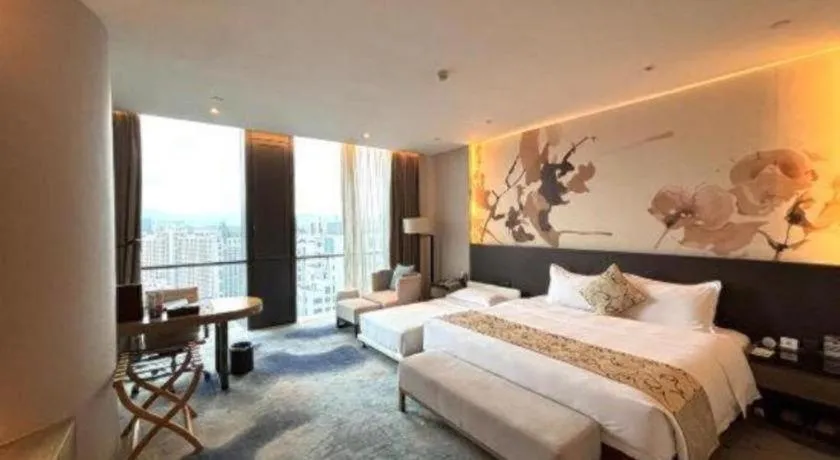 Bed in LONGYAN JINGHUA FLIPORT HOTEL