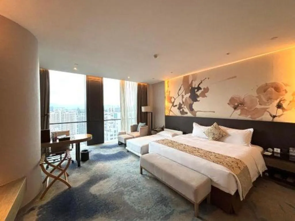 Bed in LONGYAN JINGHUA FLIPORT HOTEL