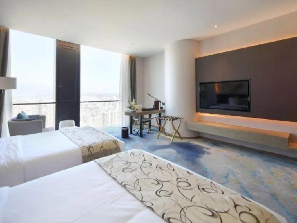 Bed in LONGYAN JINGHUA FLIPORT HOTEL