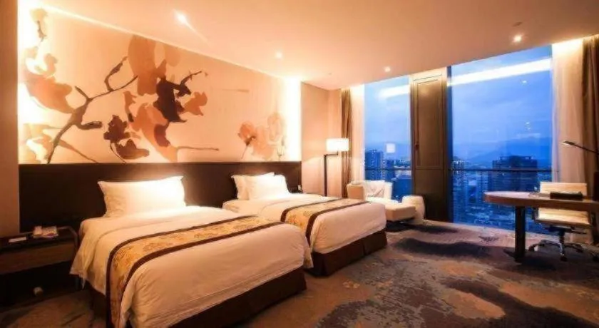 Bed in LONGYAN JINGHUA FLIPORT HOTEL