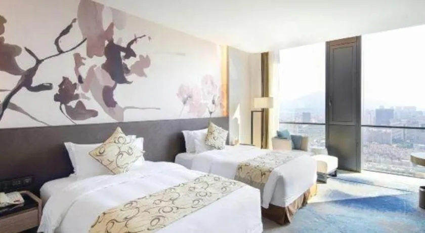 Bed in LONGYAN JINGHUA FLIPORT HOTEL