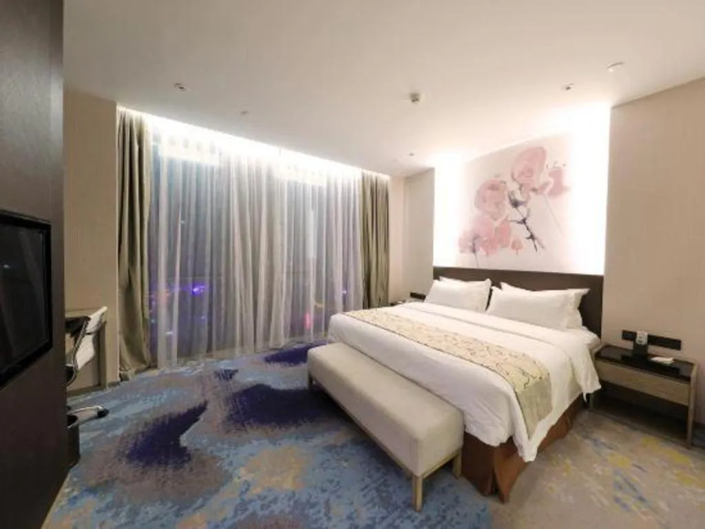 Bed in LONGYAN JINGHUA FLIPORT HOTEL
