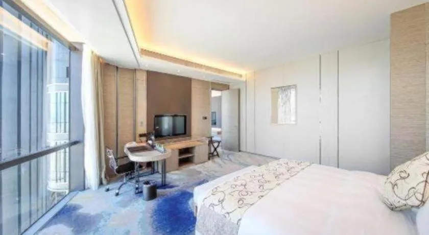 Bed in LONGYAN JINGHUA FLIPORT HOTEL