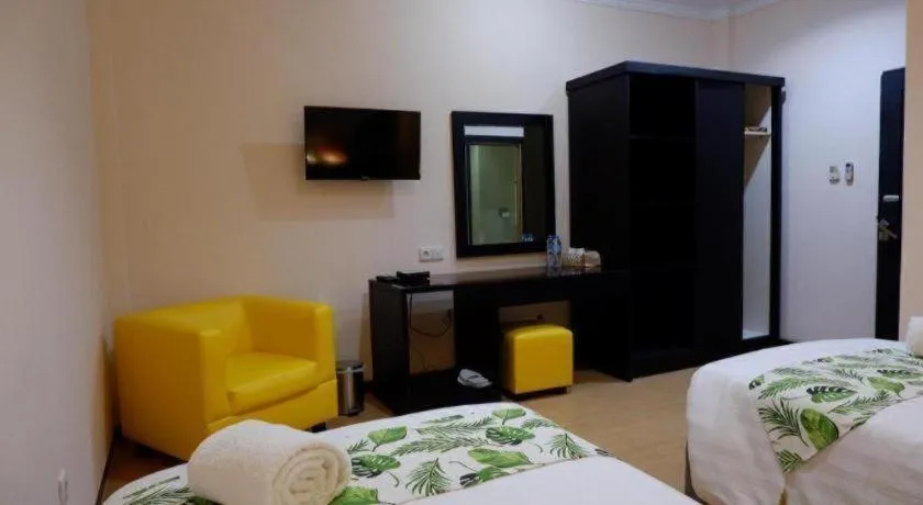 Bed in Tropical Point Hotel Syariah