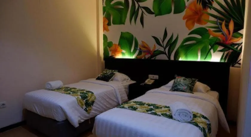 Bed in Tropical Point Hotel Syariah