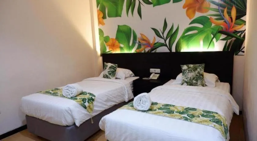 Bed in Tropical Point Hotel Syariah