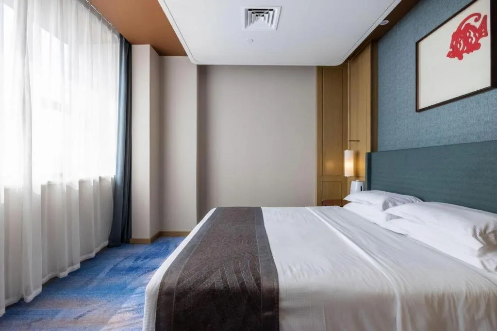 Bed in Bliss International Hotel Weihai