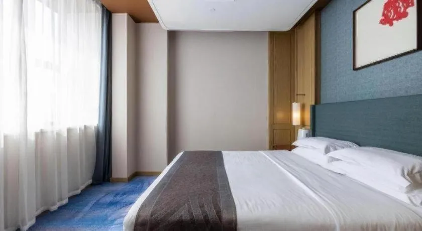 Bed in Bliss International Hotel Weihai