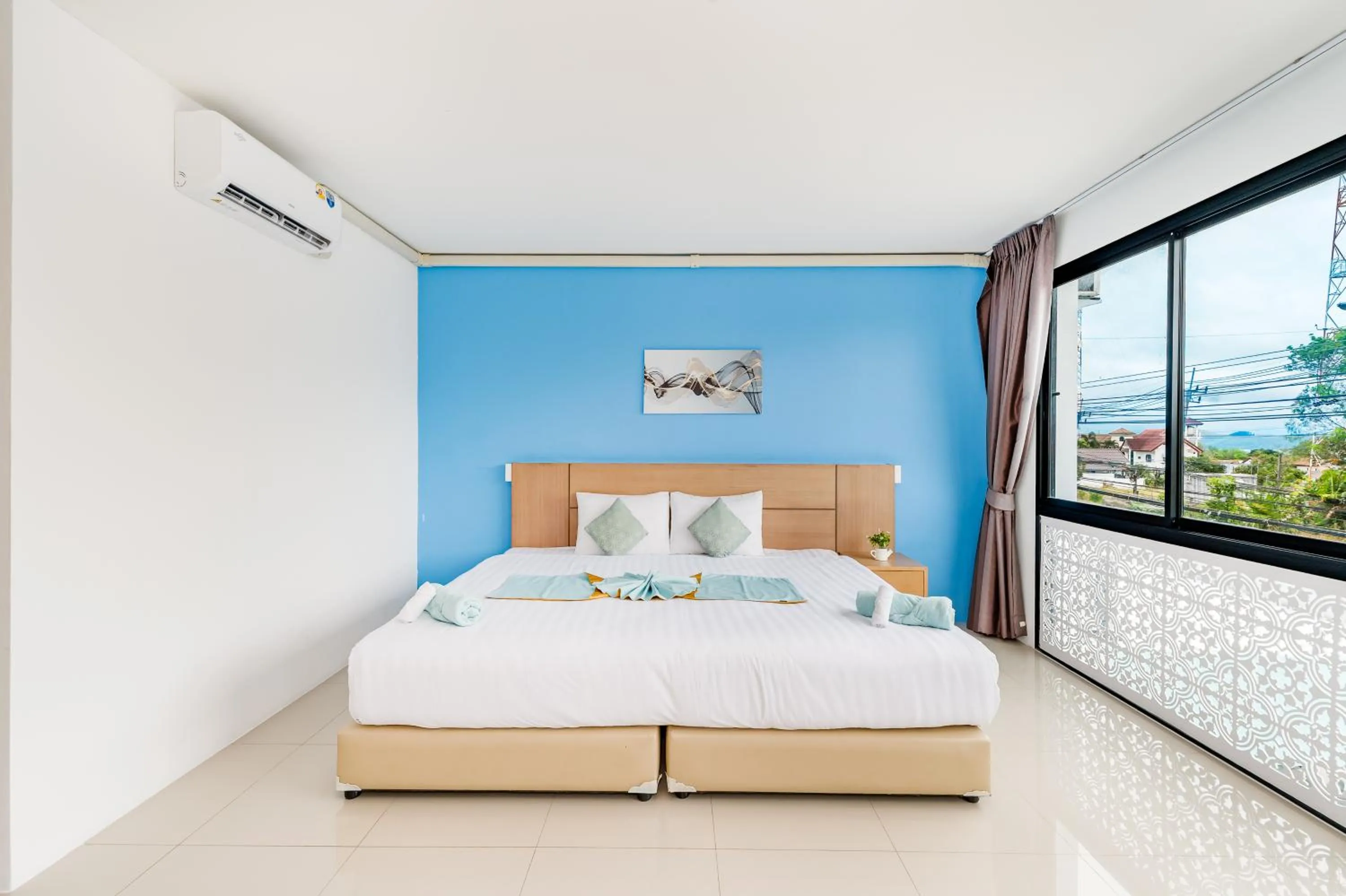 Bed in De Blue Sea Rawai Hotel