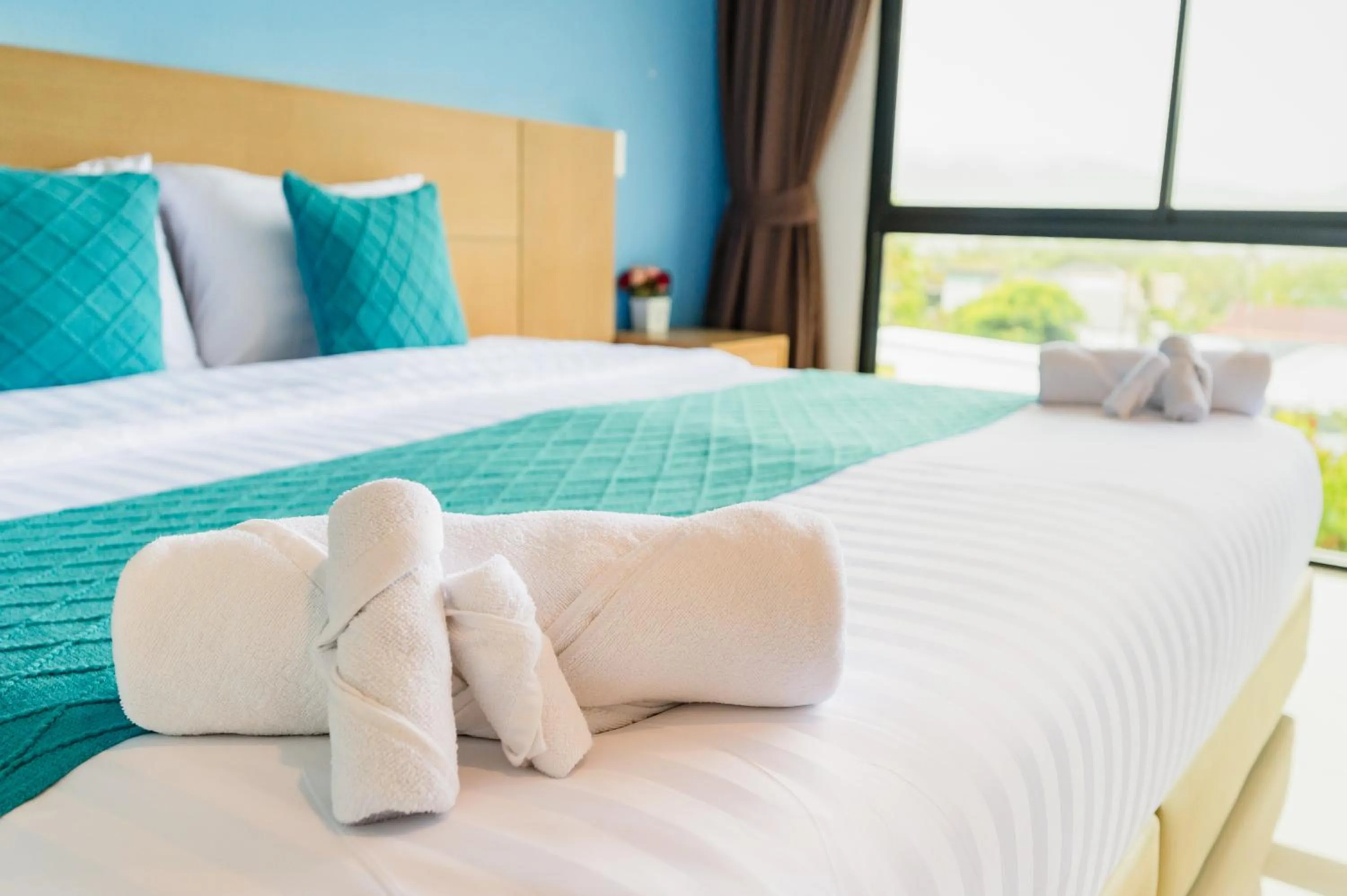 Bed in De Blue Sea Rawai Hotel