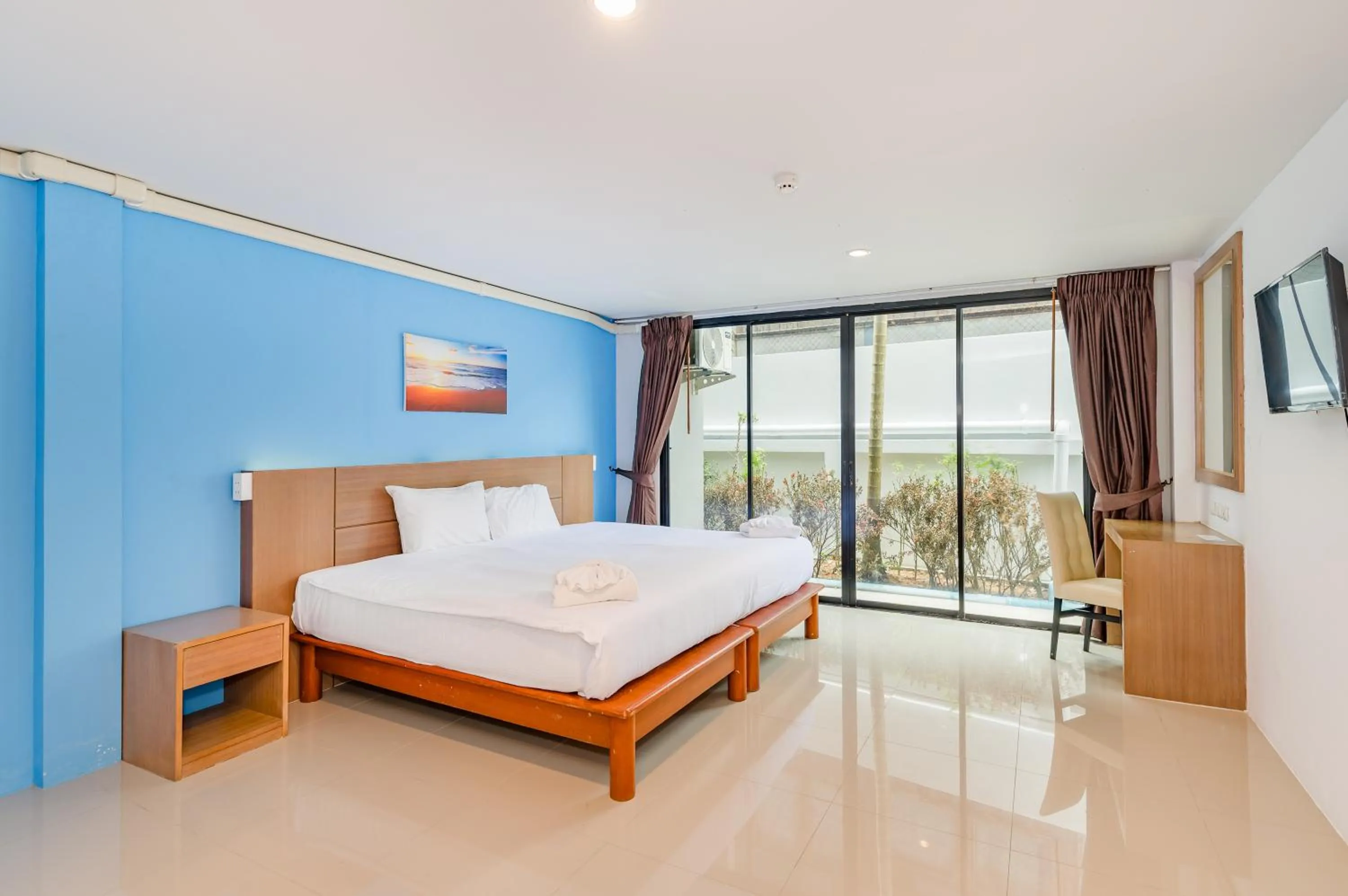 Bed in De Blue Sea Rawai Hotel