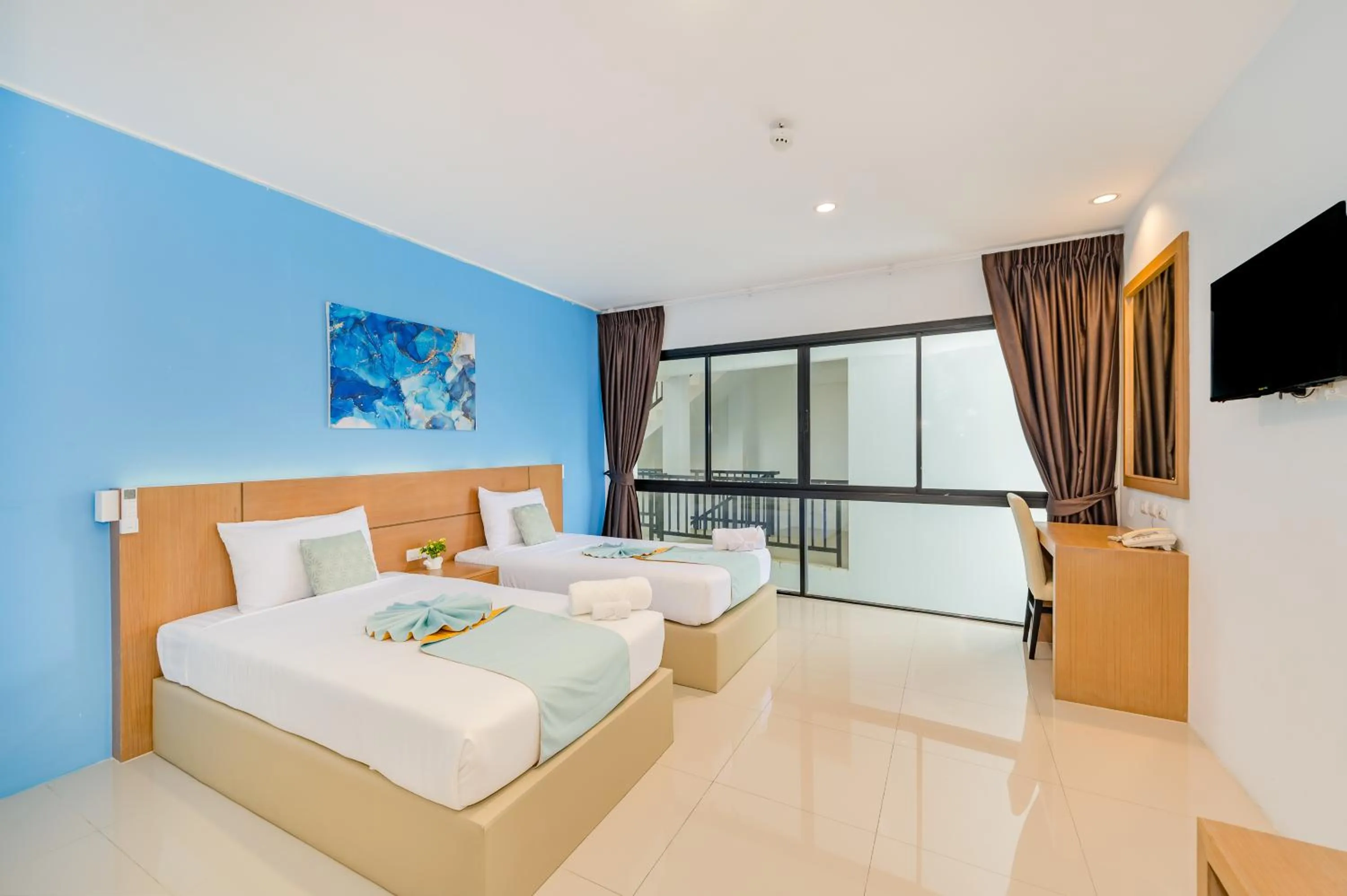 Bed in De Blue Sea Rawai Hotel