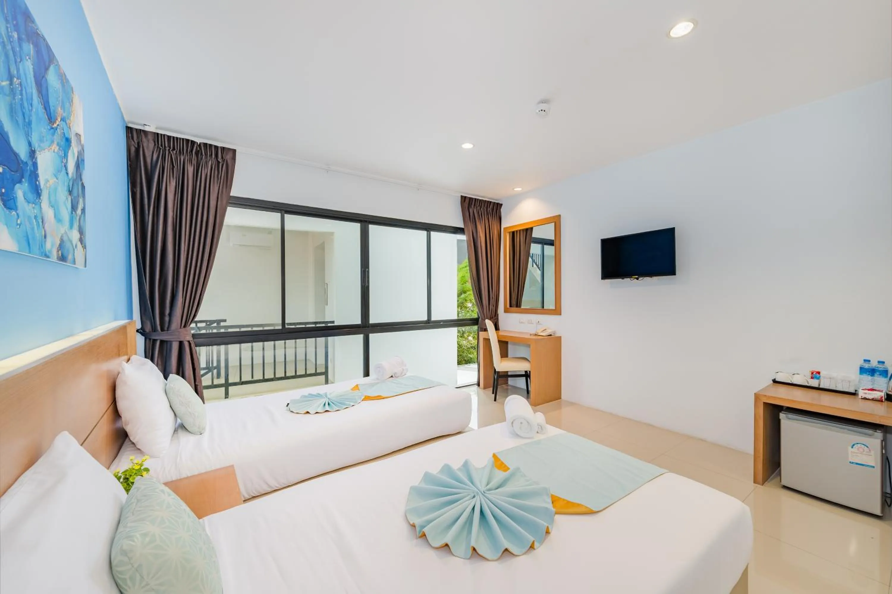 Bed in De Blue Sea Rawai Hotel