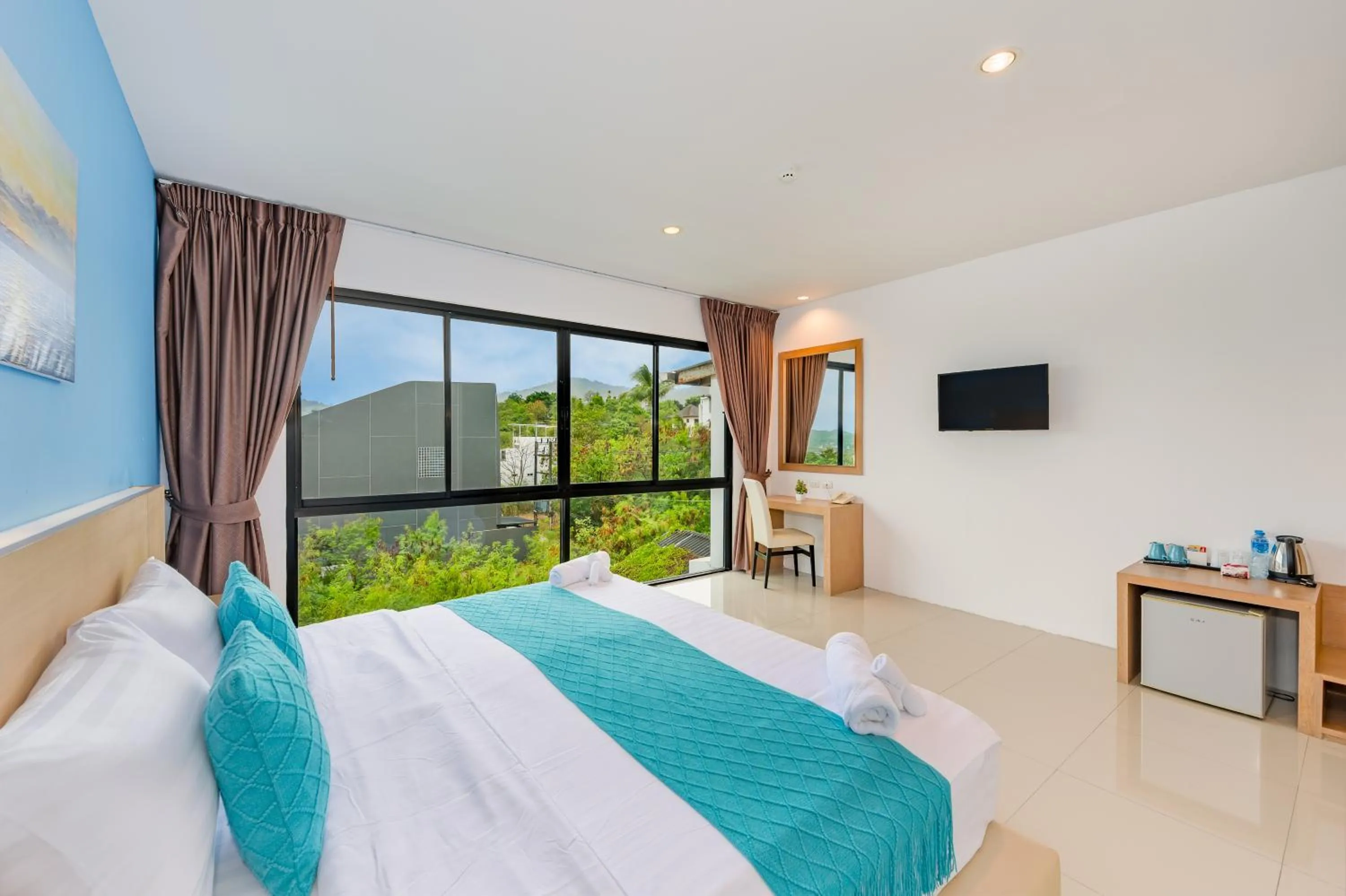 Bed in De Blue Sea Rawai Hotel