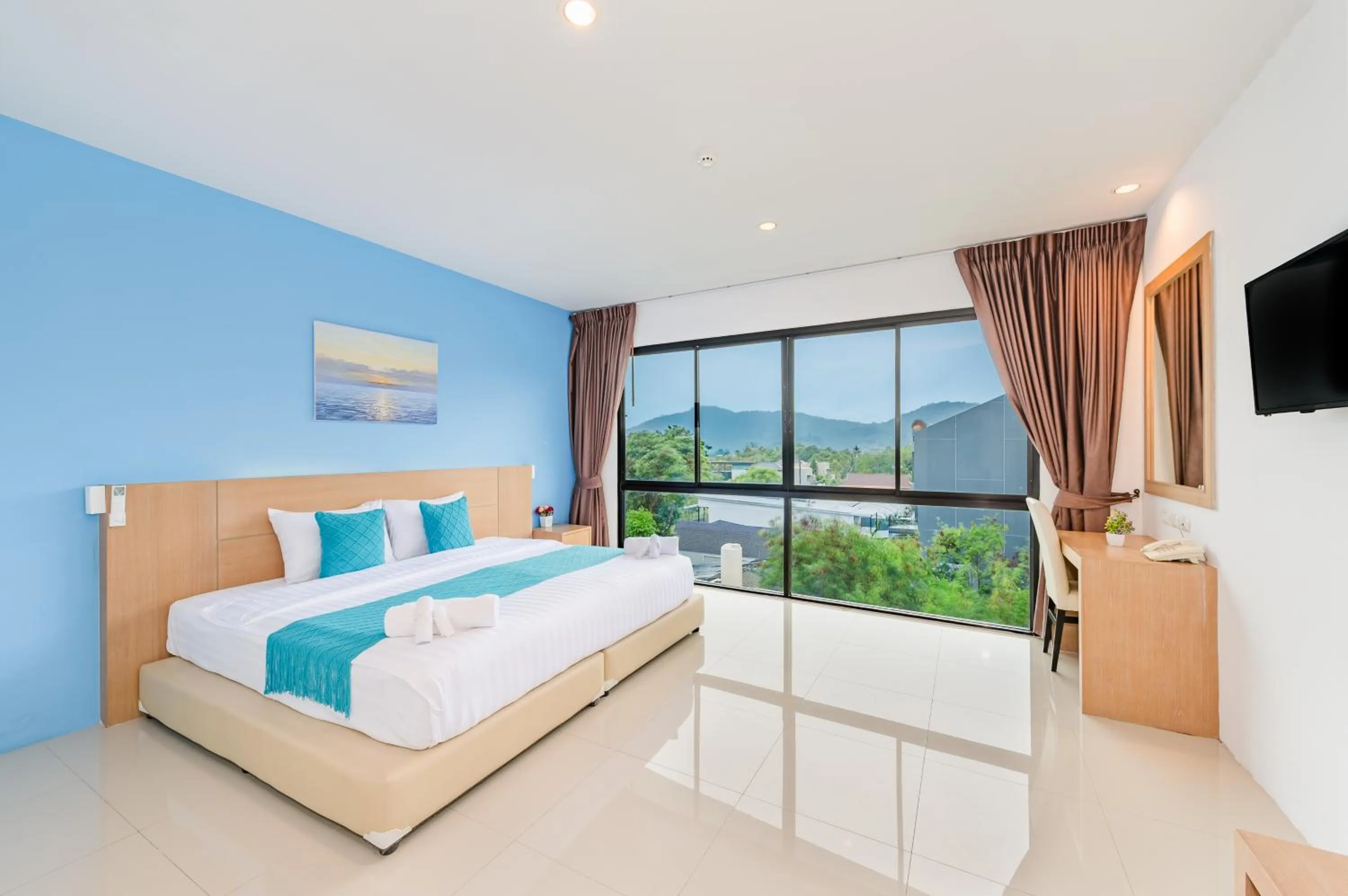 Bed in De Blue Sea Rawai Hotel