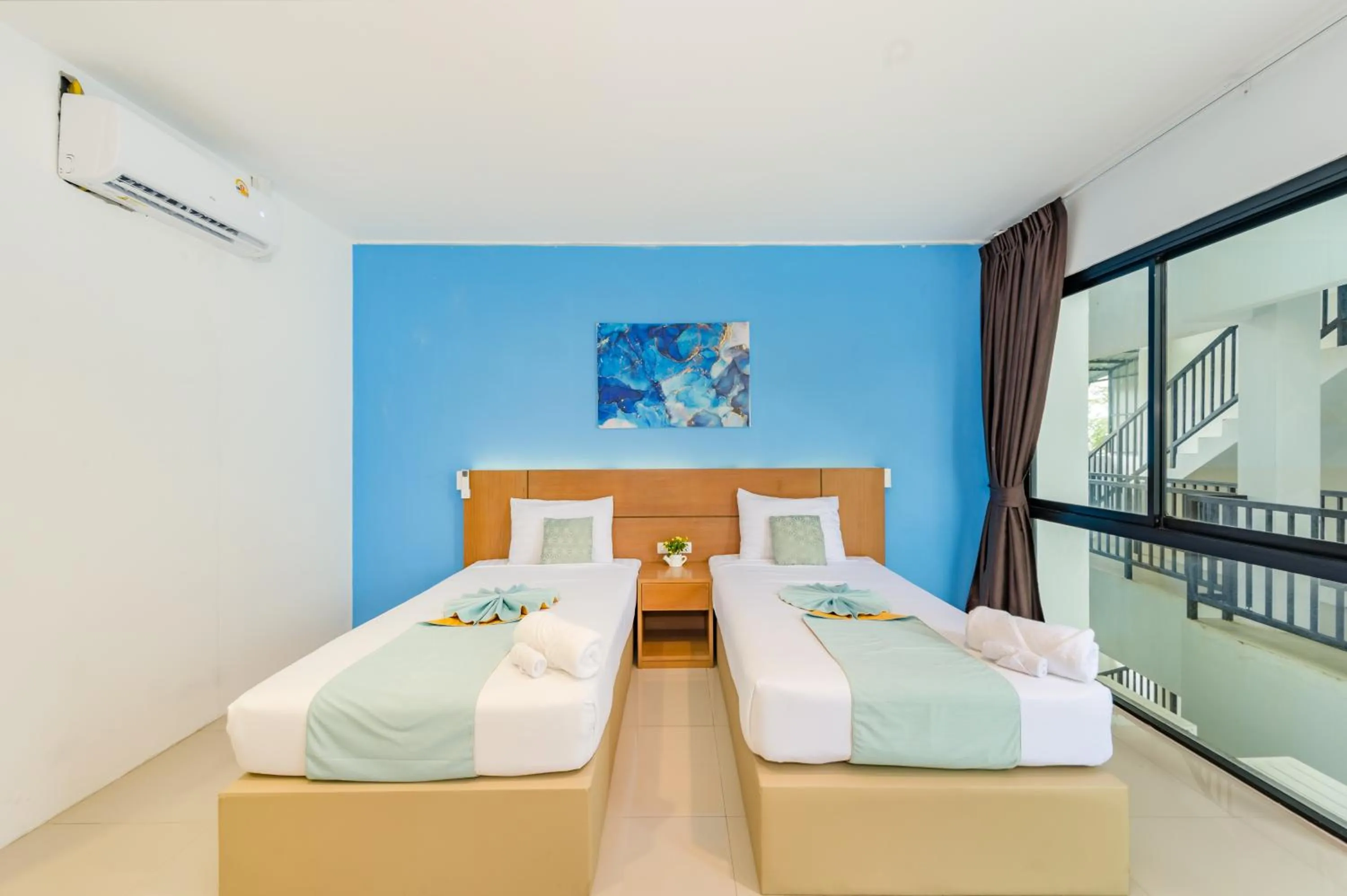 Bed in De Blue Sea Rawai Hotel