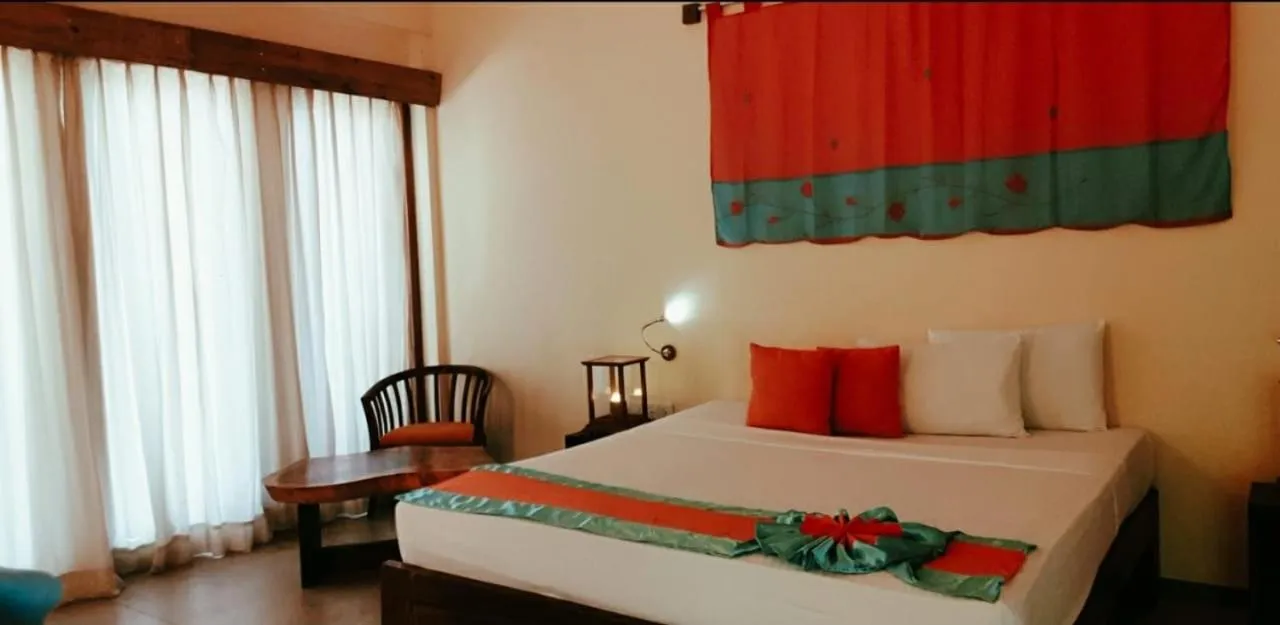 Bed in Giman Free Beach Resort Pasikuda