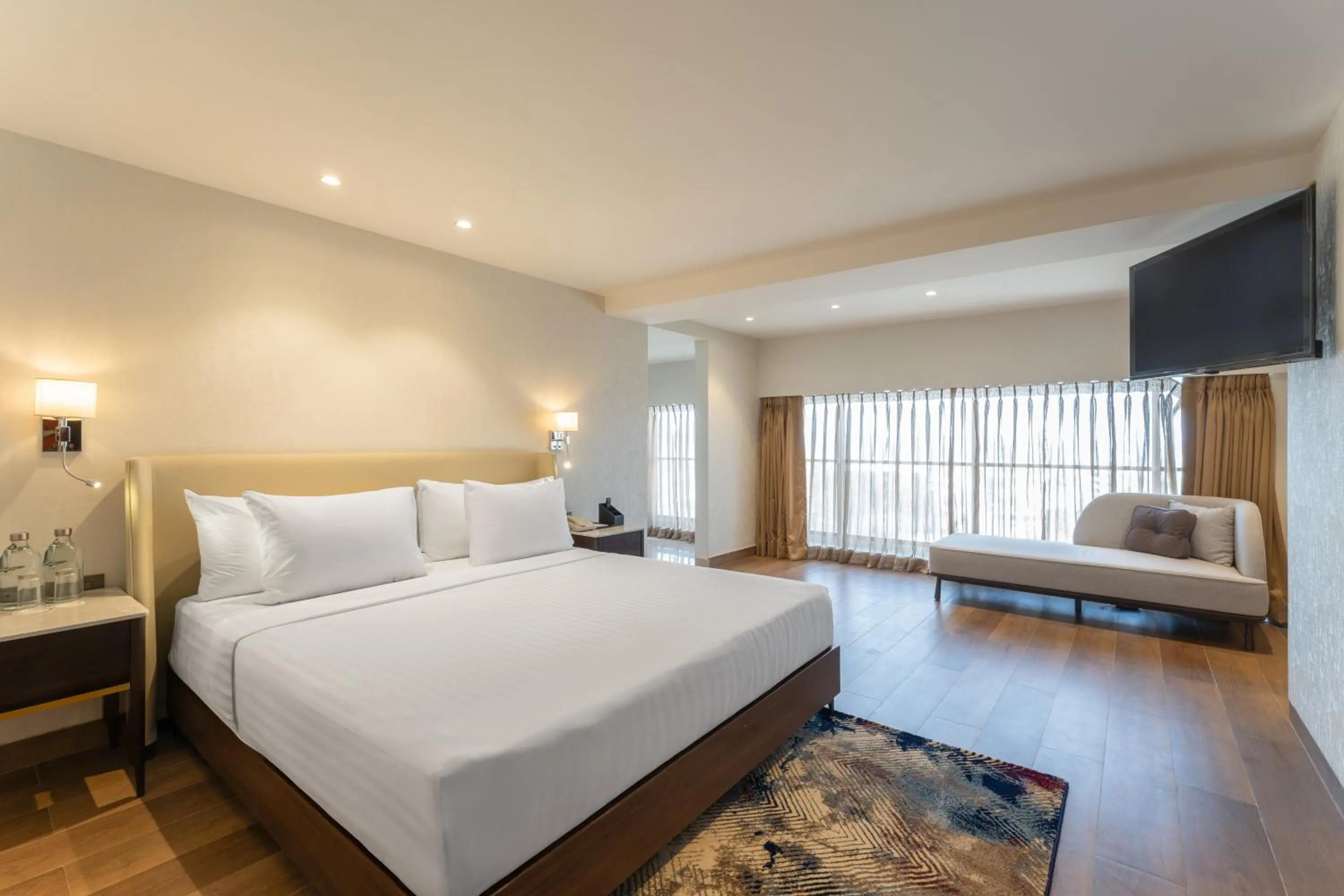 Seating area, Bed in Clarks Inn Suites Hyderabad Airport