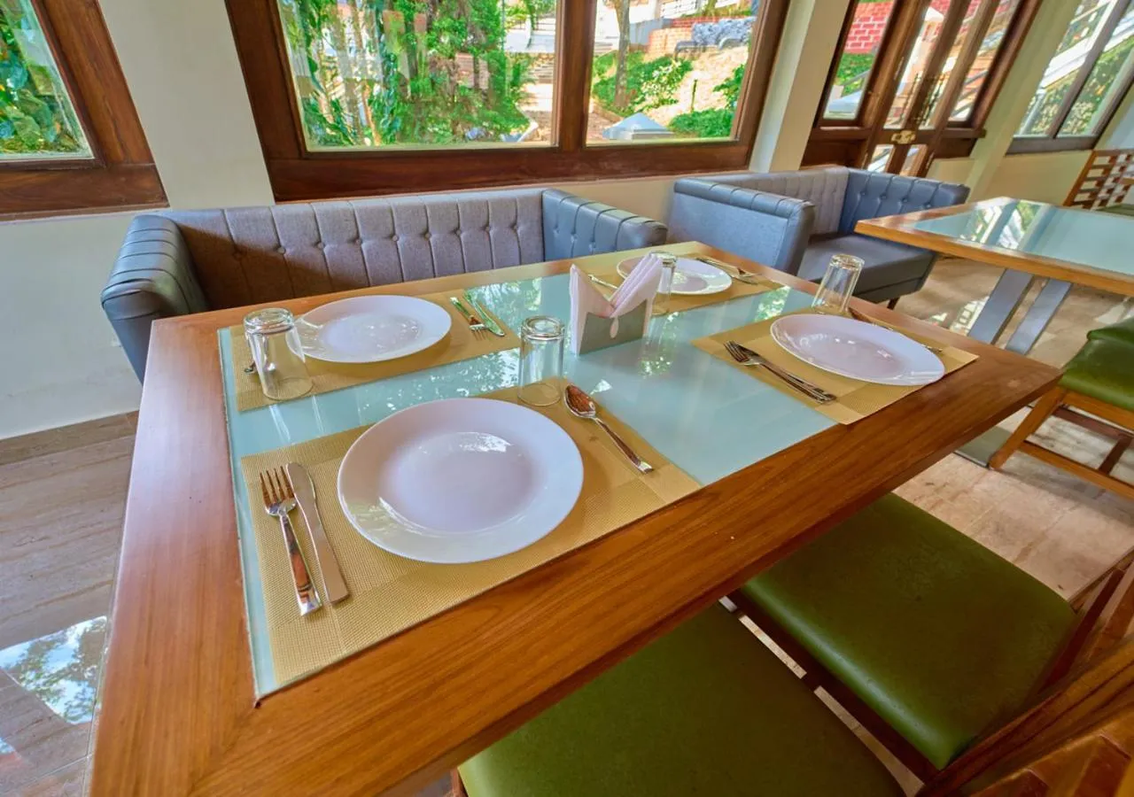 Living room in Ushasree Wayanad Premium Pool Resort by VOYE HOMES