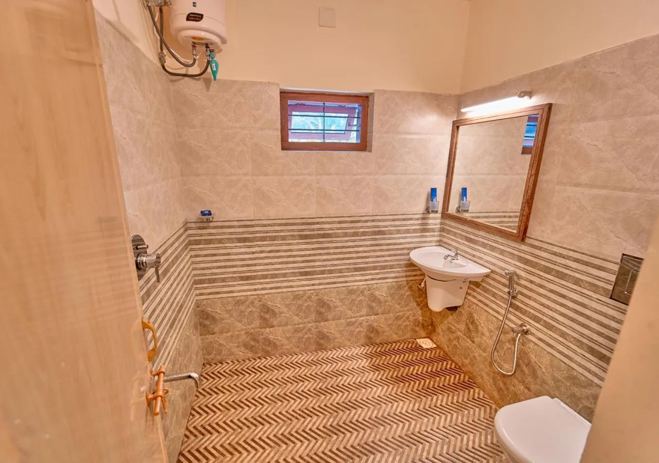 Shower in Ushasree Wayanad Premium Pool Resort by VOYE HOMES