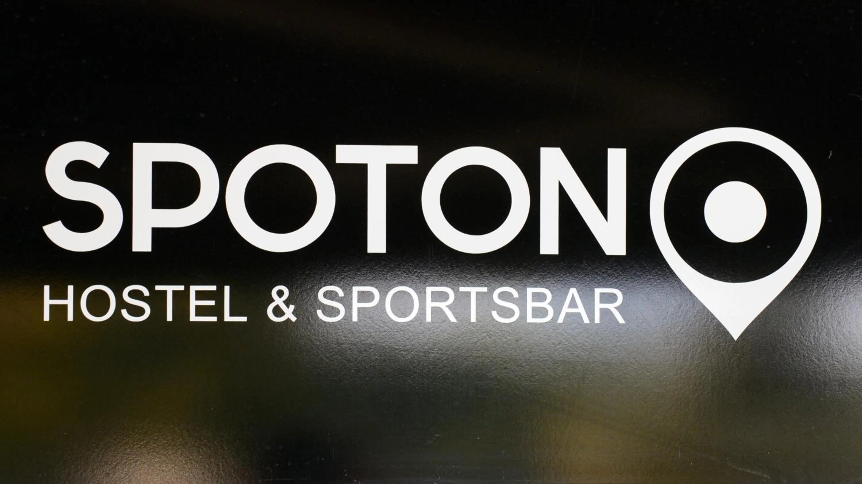 Property logo or sign in Spoton Hostel & Sportsbar