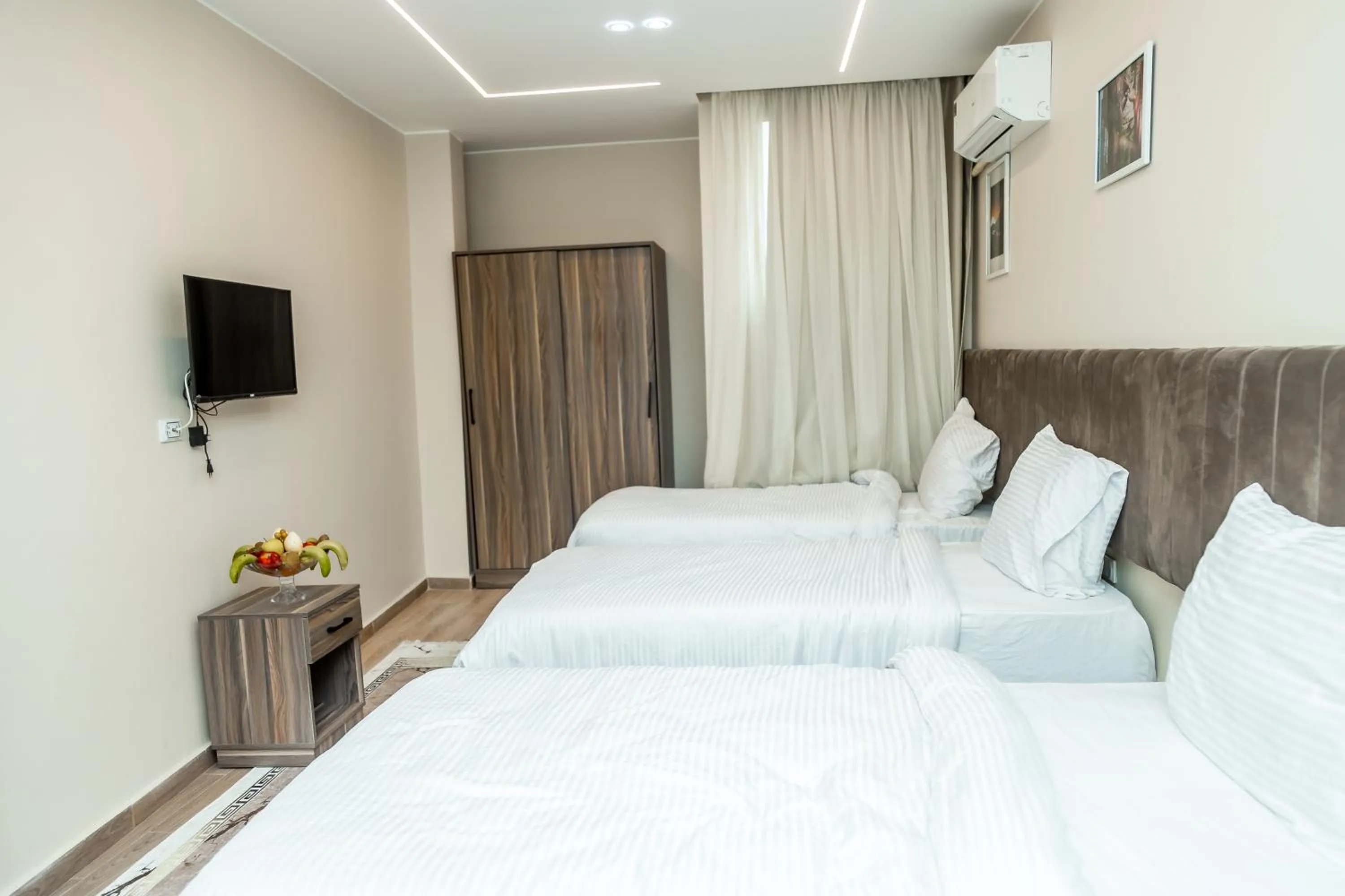 Communal lounge/ TV room, Bed in Night Pyramids Inn Hotel