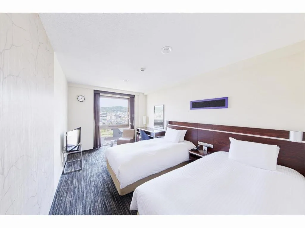 Bed in Hotel Sunroute Kyoto