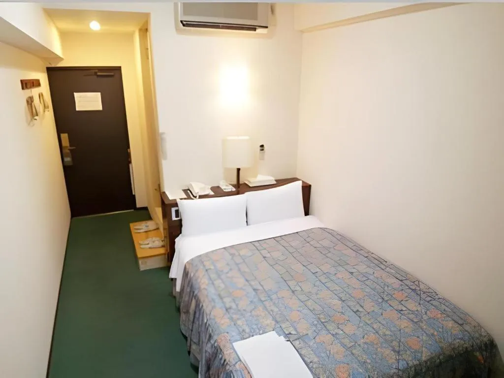 Bed in Hotel Tetora Tsurumi