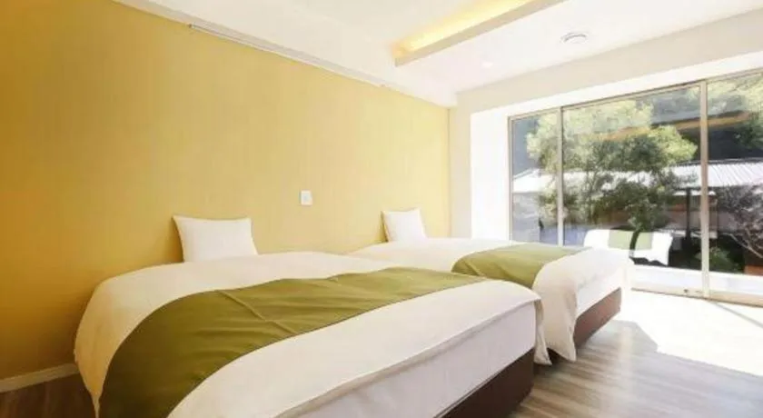 Bed in Hotel Myoken Tanaka Kaikan