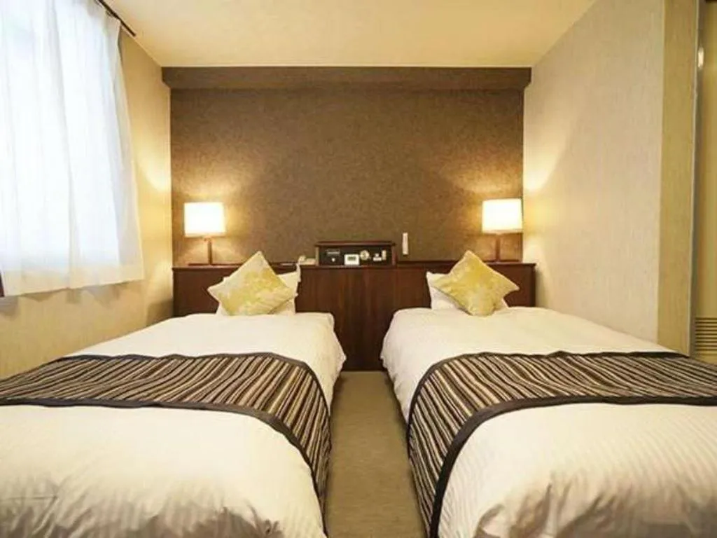 Bed in Hotel AreaOne Miyazaki City