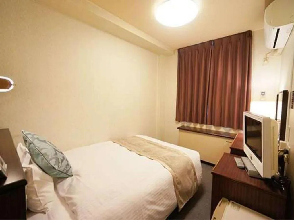 Bed in Hotel AreaOne Miyazaki City