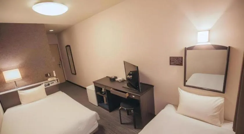 Bed in Hotel AreaOne Miyazaki City