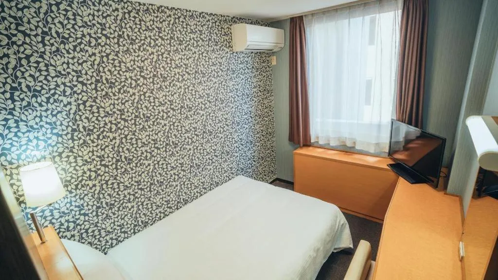 Bed in Hotel AreaOne Miyazaki City