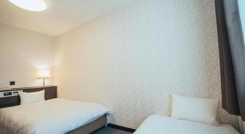 Bed in Hotel AreaOne Miyazaki City